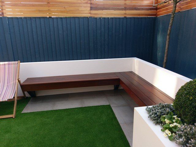 hardwood corner bench rendered wall light grey paving london garden builders