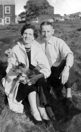 Restored black and white photo of a couple sitting in a park.