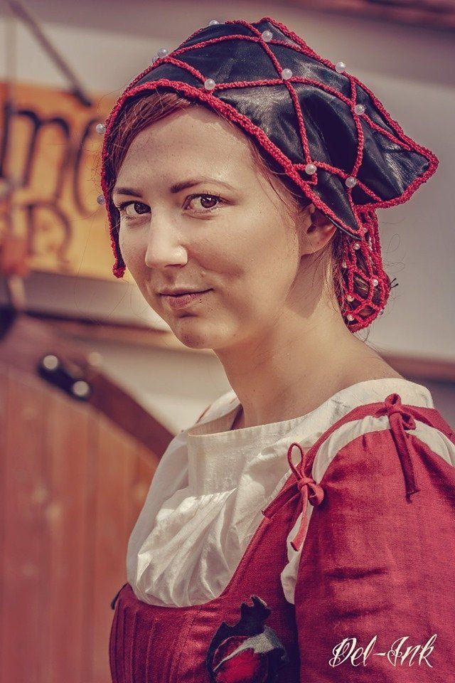 Kundin trägt ein Fuchsikat - schwarze Kappe mit rotem Perlenhaarnetz