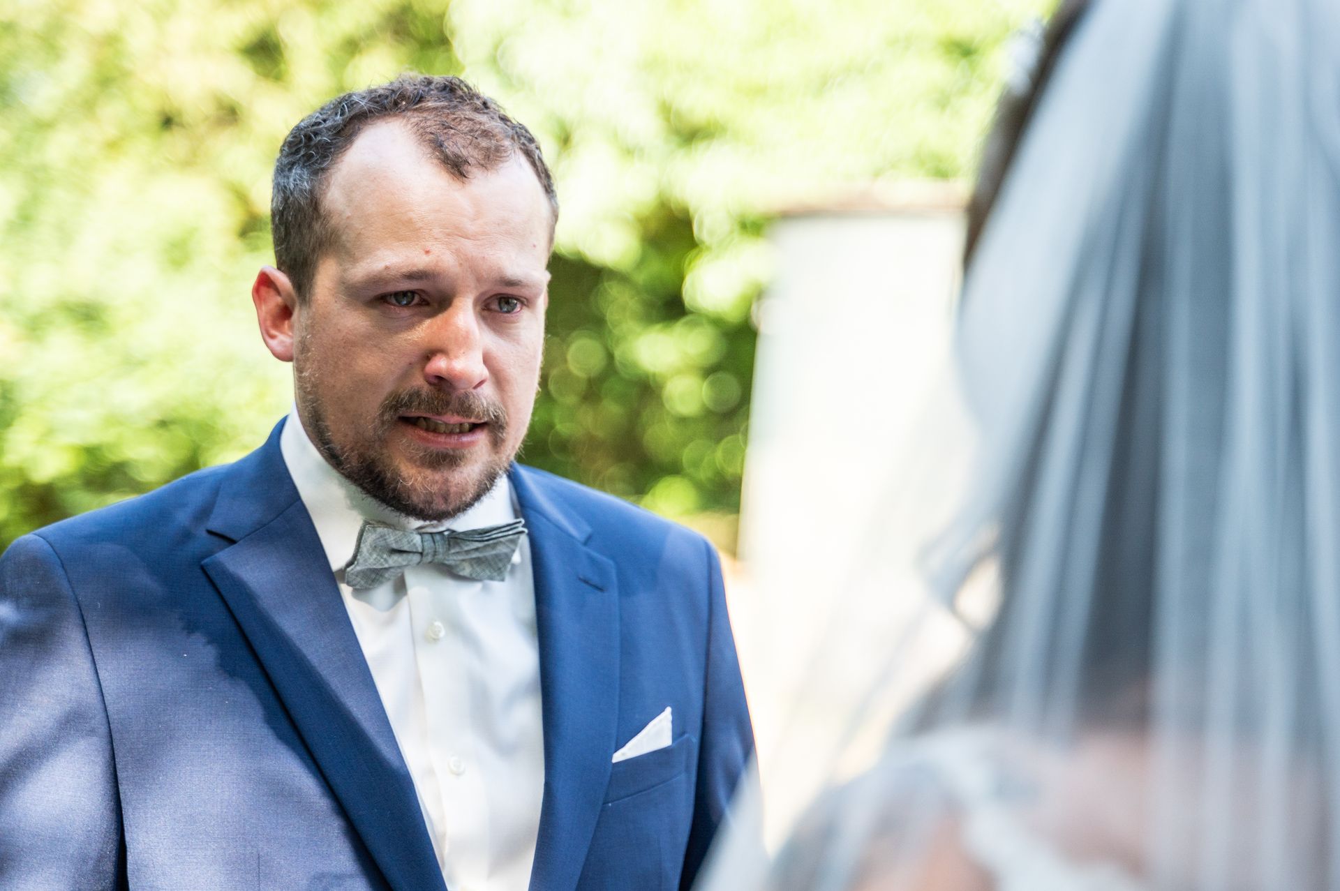 Emotionaler Bräutigam mit Tränen in den Augen bei der Trauung