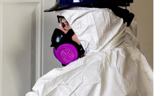 Surveyor assessing asbestos risks in a commercial property during a management survey to protect tenants