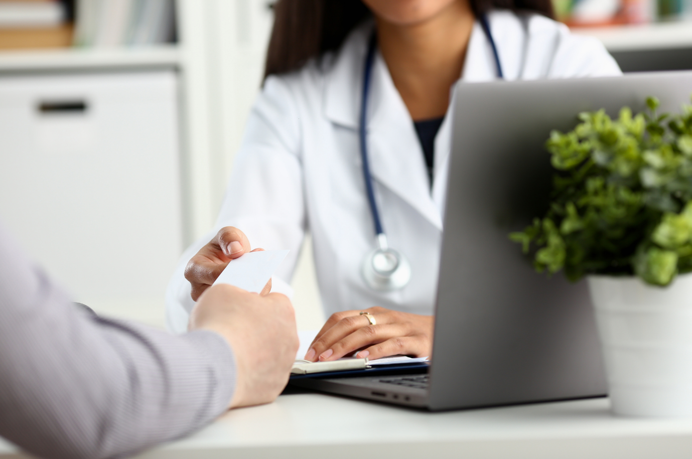 female doctor shaking hands with patient