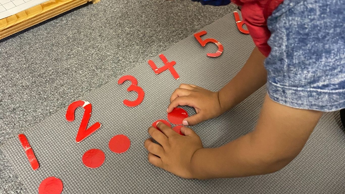 A view of the Montessori odds & evens - red cut-out numbers and the correct amount of counters underneath.