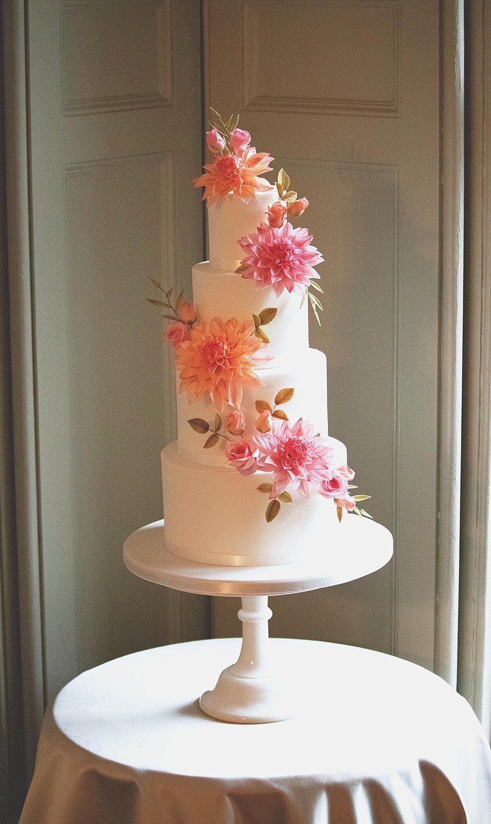 Wedding cake four tier with orange and pink sugar flowers