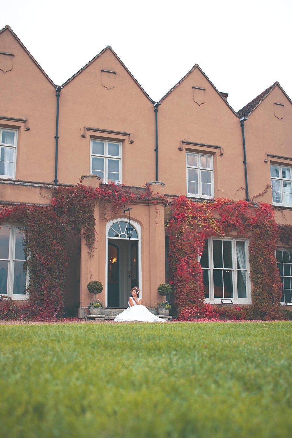 Bride sitting outside Nurstead Court Kent
