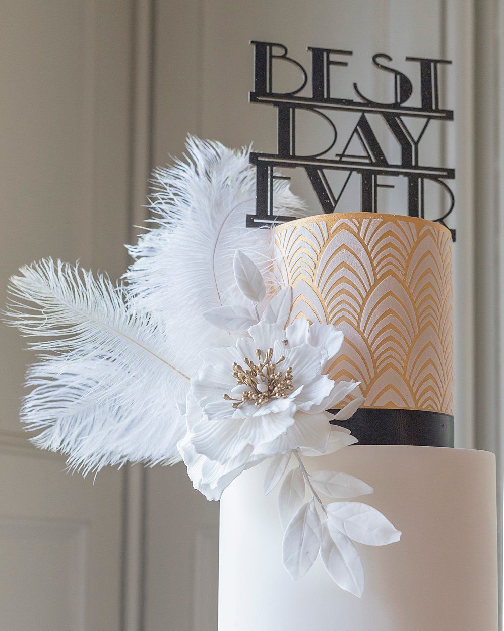 Best day ever sign on top of white wedding cake