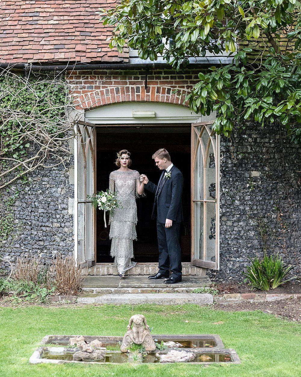 Bride and Groom stepping out of Nurstead Court Kent