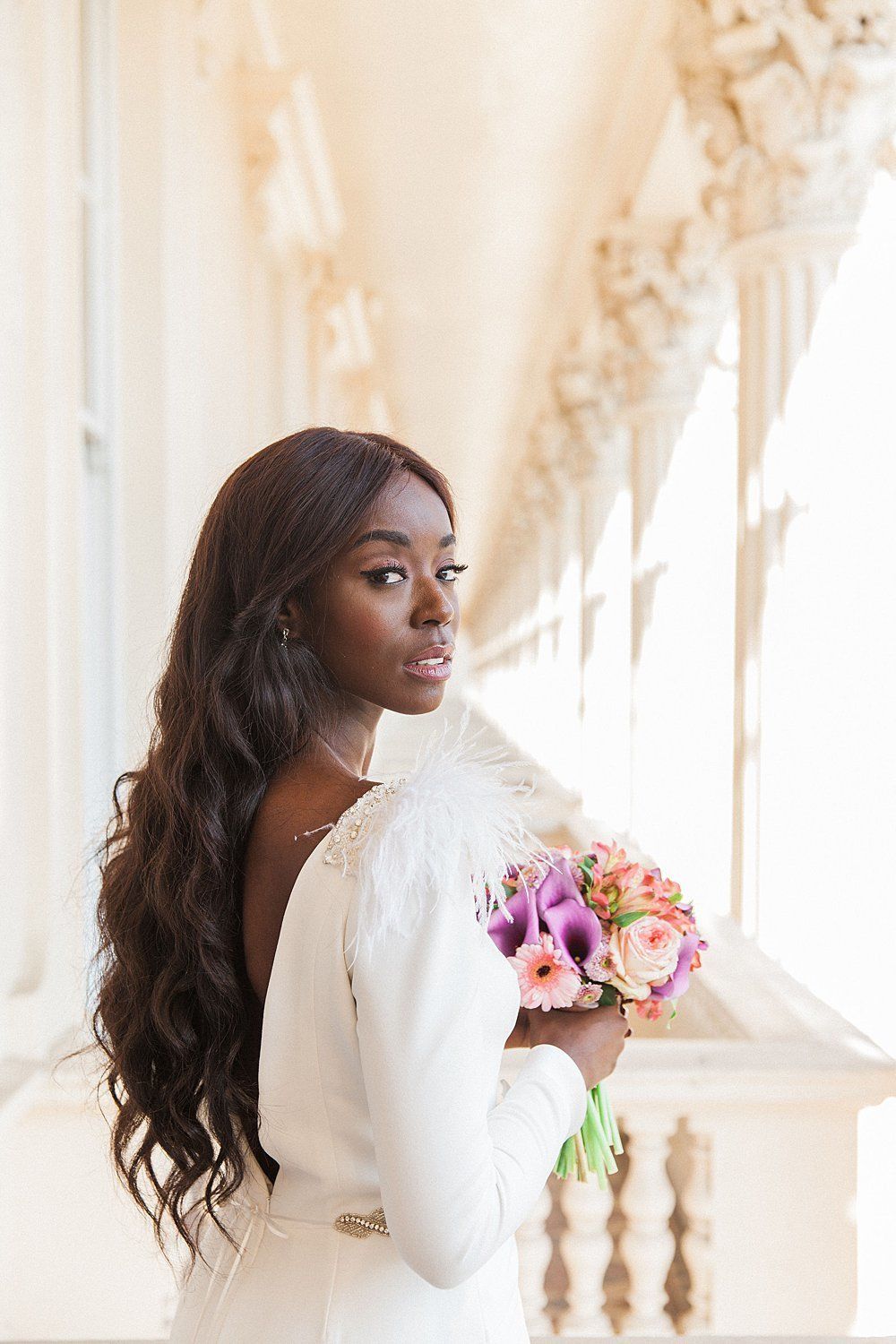 Bride holding bouquet on gallery at Carlton House Terrace