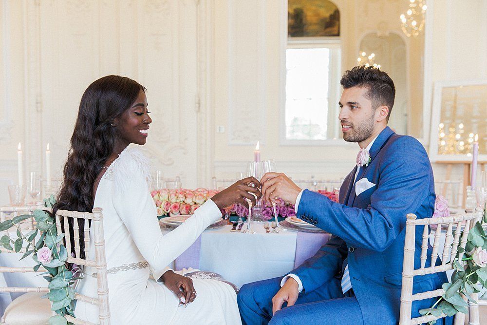 Bride and groom raising champagne glasses Carlton House Terrace