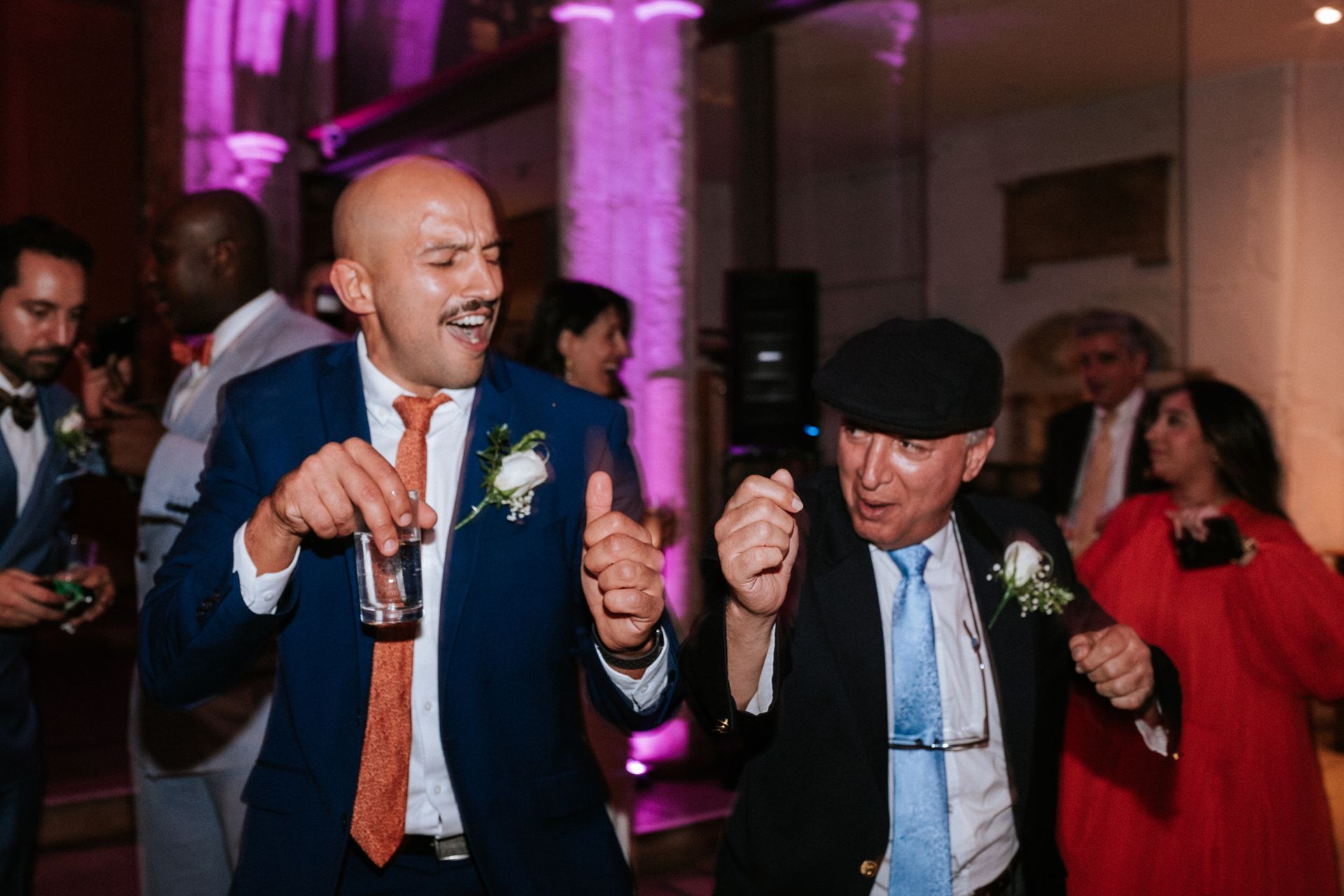Two white men dancing at a wedding