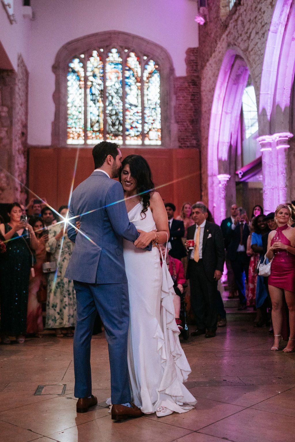 Bride and groom leaning on each other as they slow dance