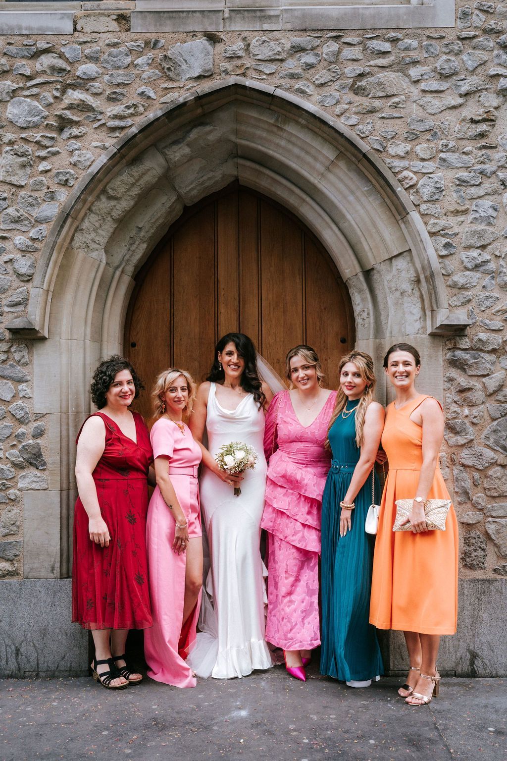 5 white ladies standing with bride and smiling to the camera