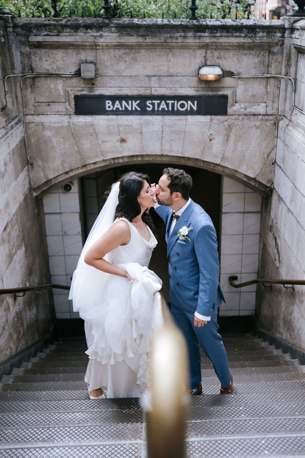 Arab bride and groom kissing outside bank train station