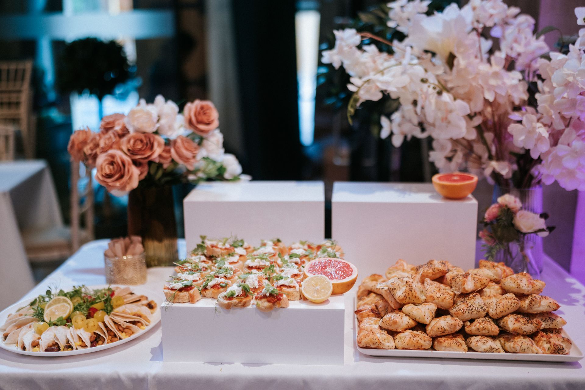 Buffet food displayed on white stands
