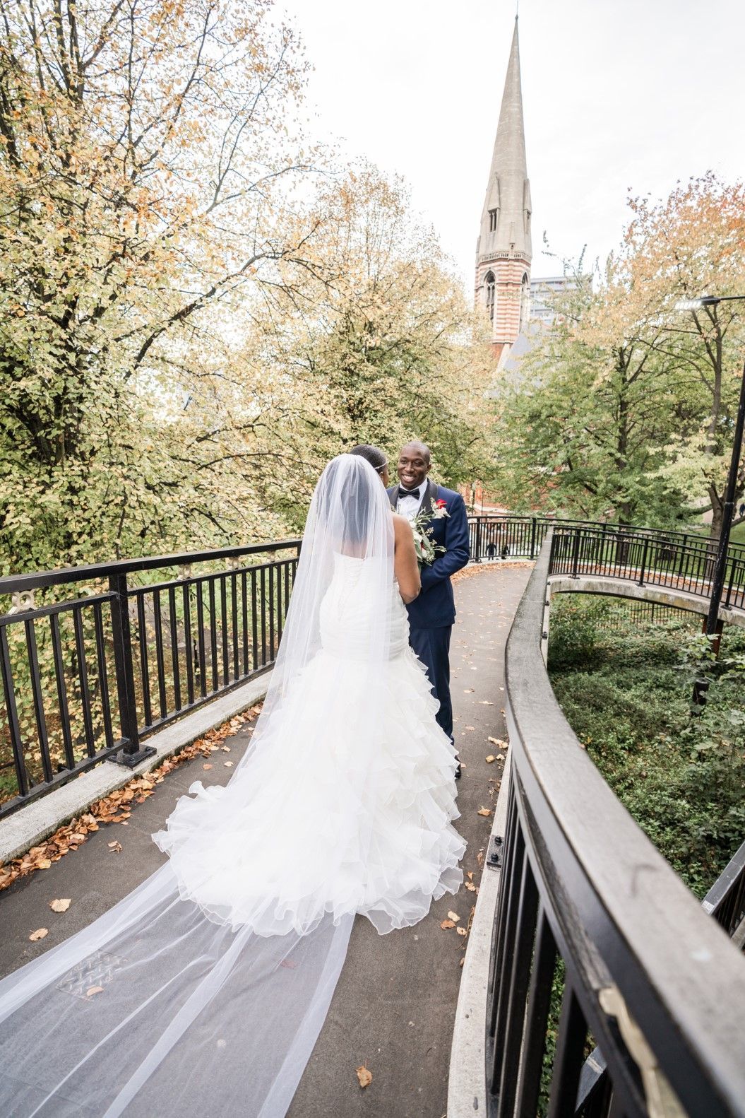 black bride and groom standing on bridge in madia vale london