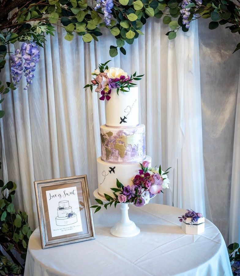 Elegant white and lilac 3 tier wedding cake with real flowers