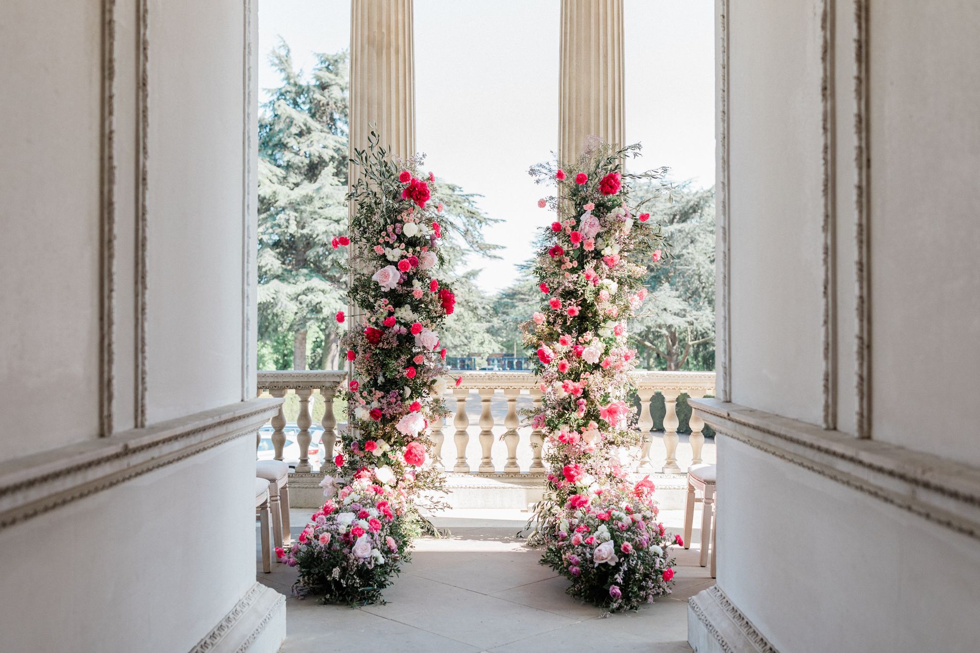 Colourful wedding ceremony arch backdrop at Chiswick House London
