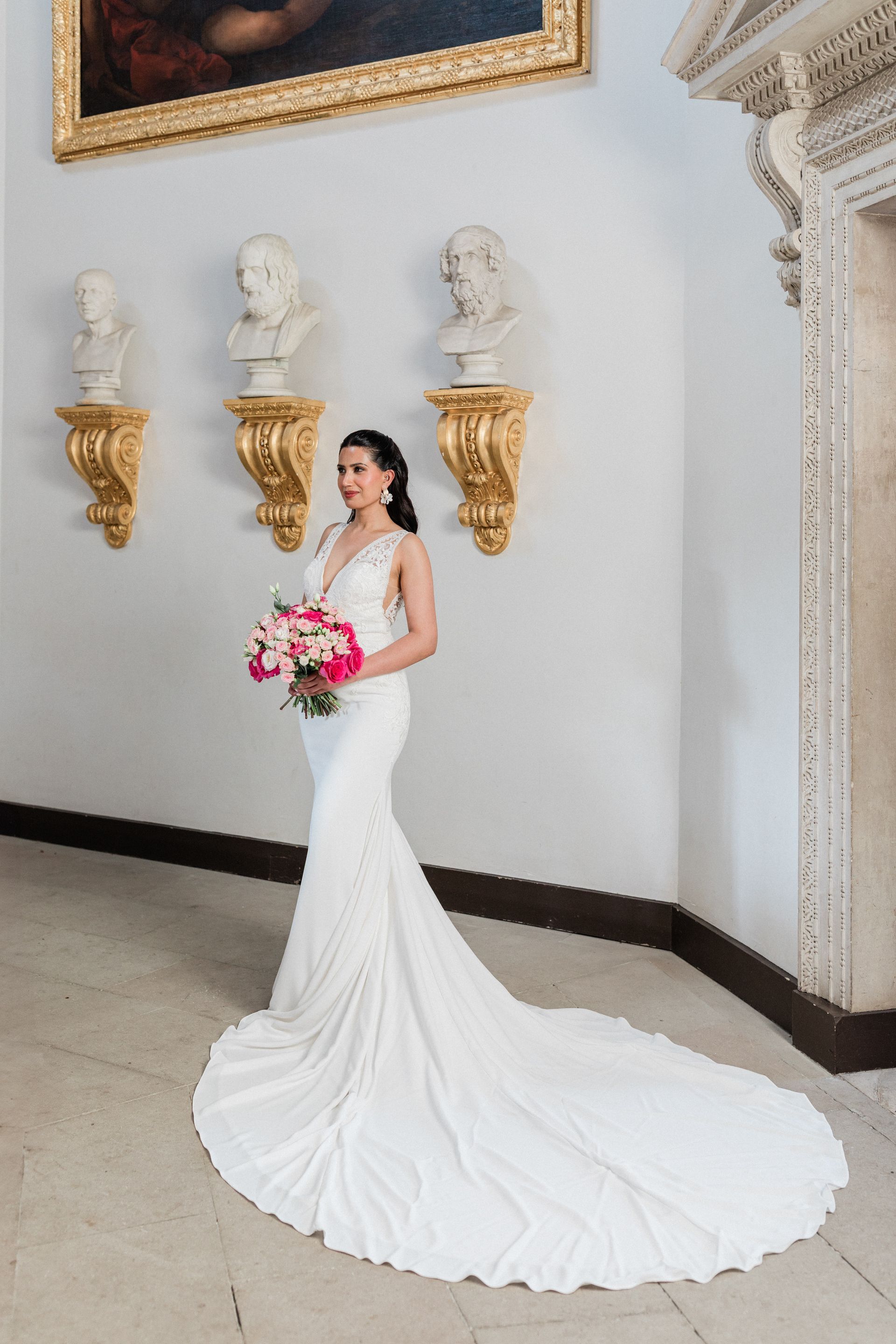 Bride in a full white gown with a train and colourful bouquet planned by Pearline Events at Chiswick House, London