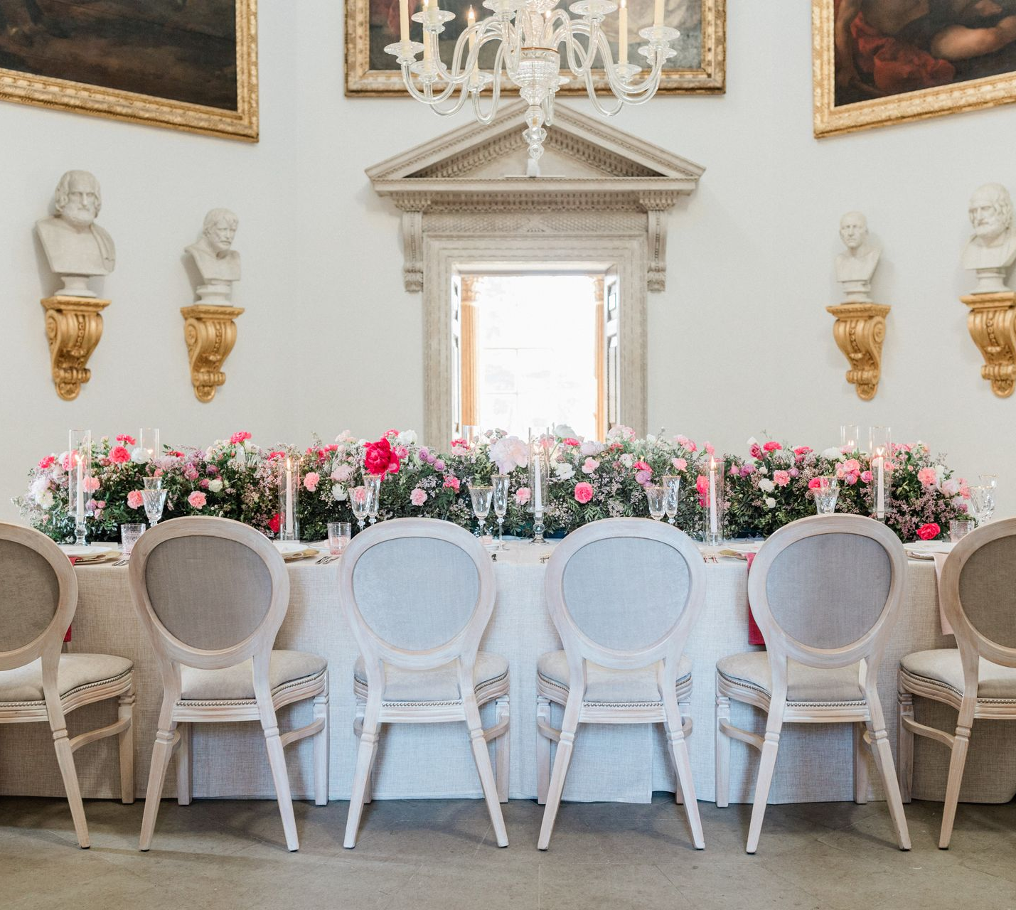 Picture of pink and white rose flower runner on a table with a glass charger plate and pink menu