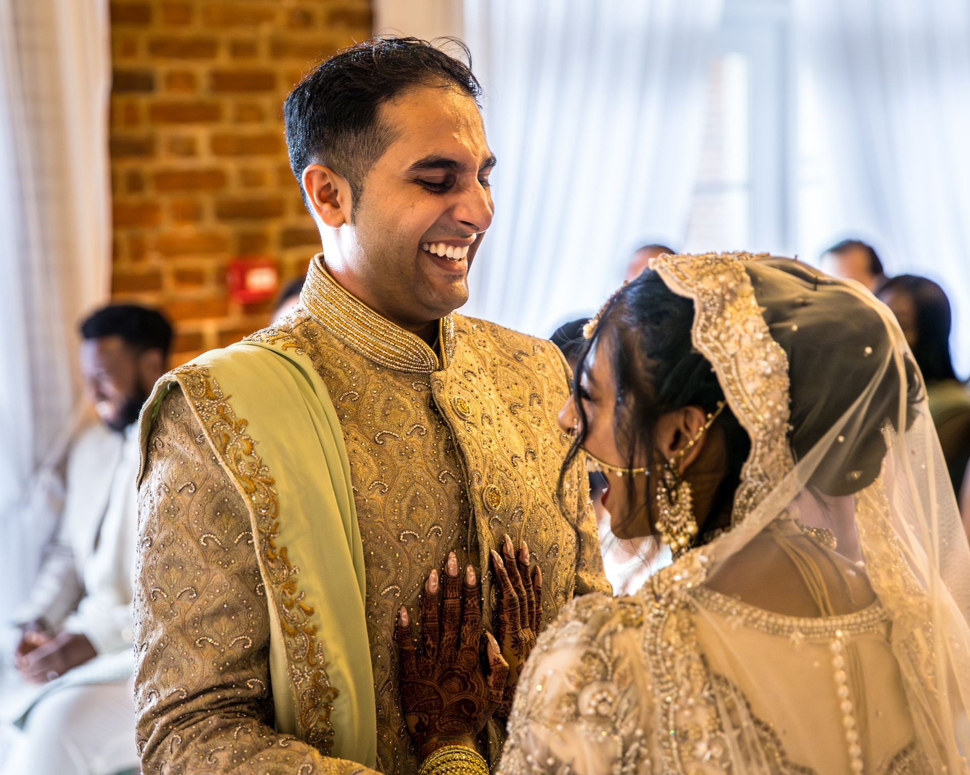 A joyful Indian couple celebrating their multicultural wedding in Greater London, expertly managed by Pearline Events.