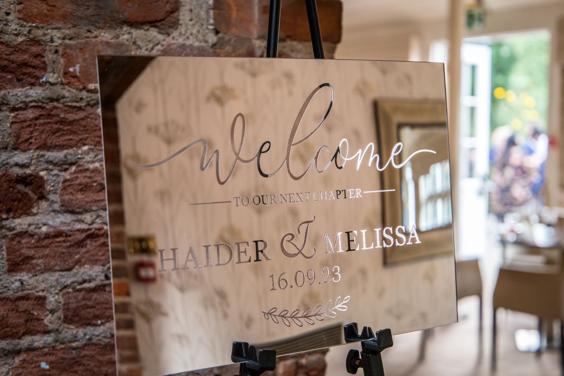 Mirrored wedding welcome sign which reads Welcome to the wedding of Haider and Melissa