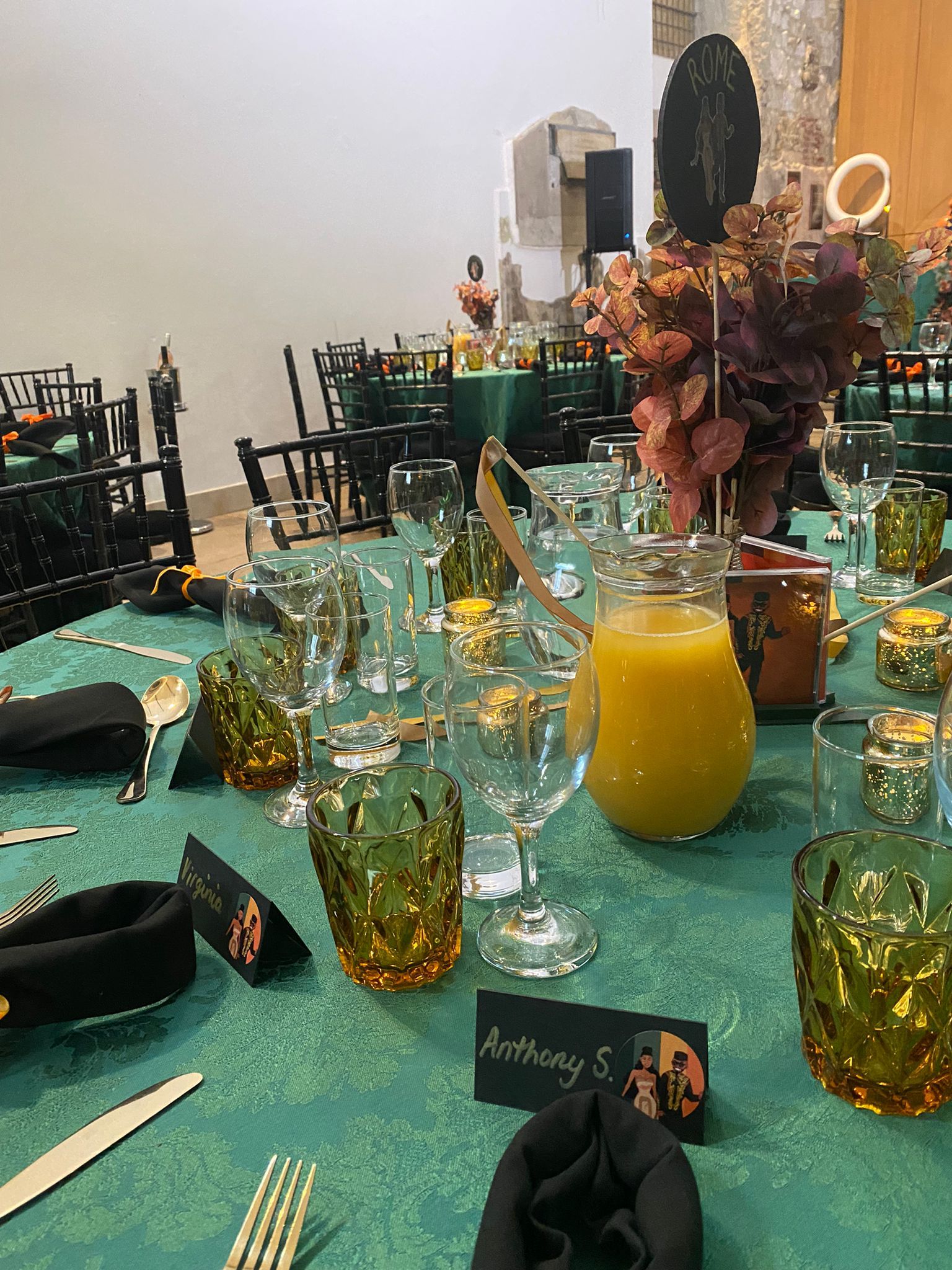 wedding reception table black napkins gold cutlery orange water glasses