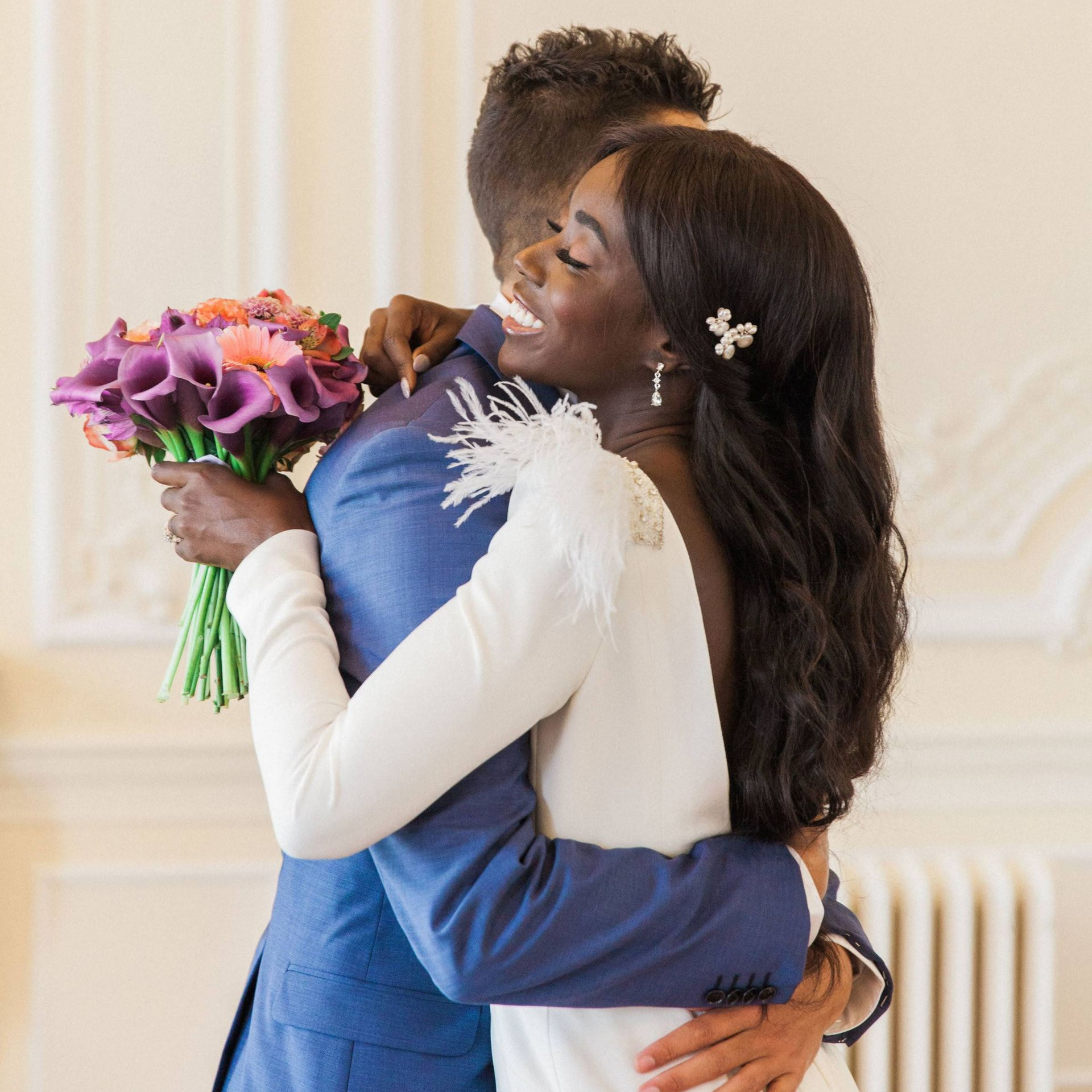 Multicultural wedding planner bride and groom hugging at London heritage fusion wedding