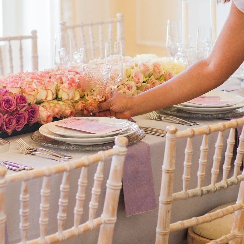 Close up of peach and purple bridal bouquet been held in hands of a black bride