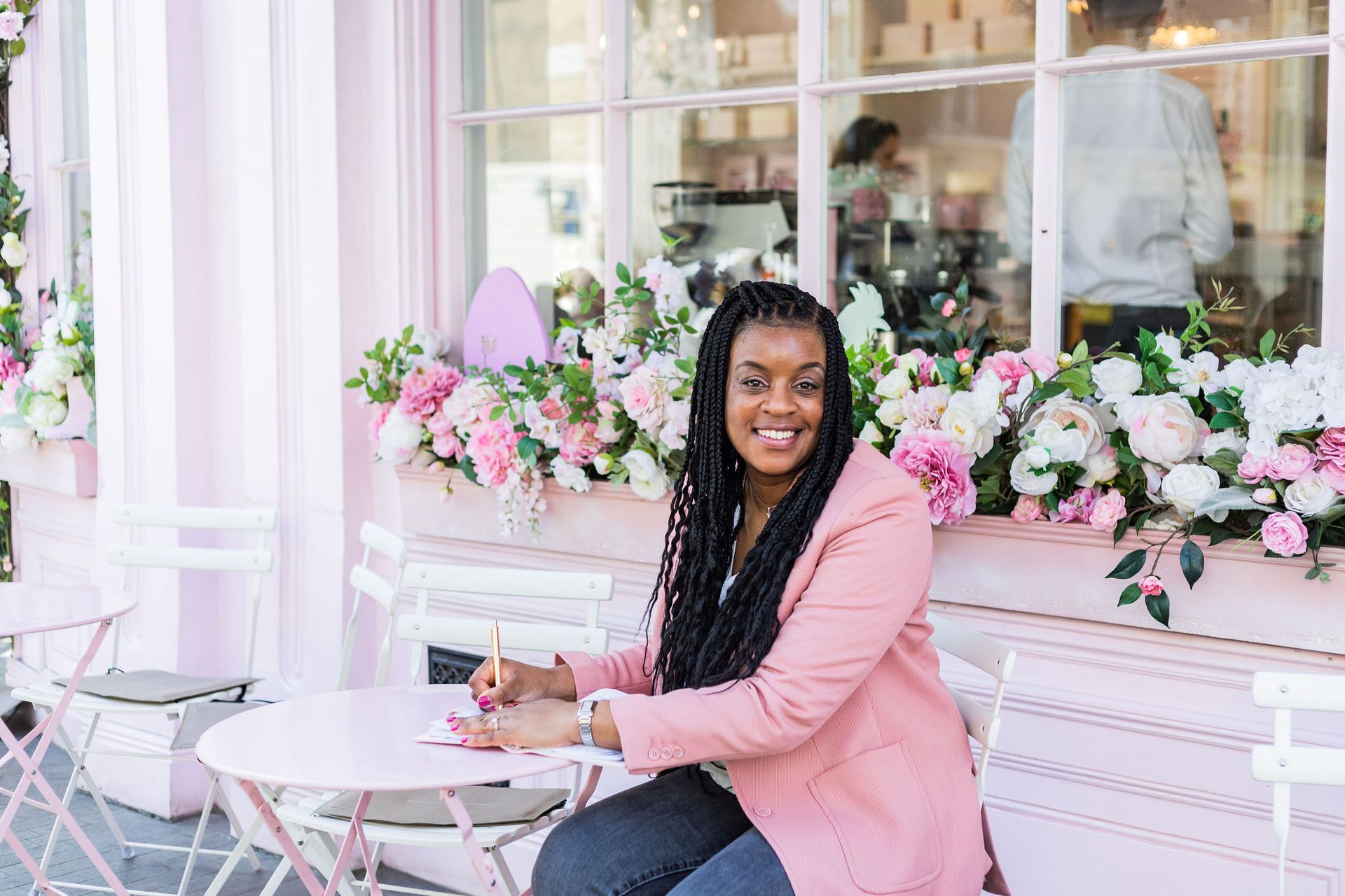 Natasha Grant founder of Pearline Events seated and smiling outside a cafe in London