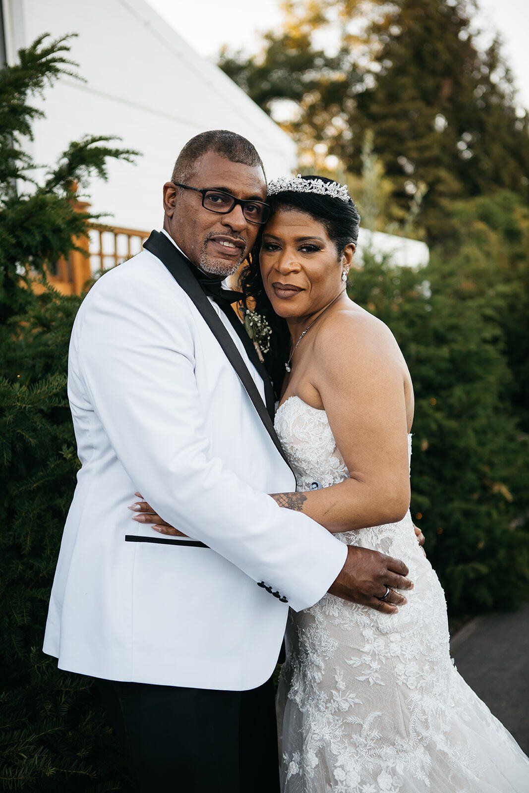 Black bride and groom hugging each other outside Club Langley