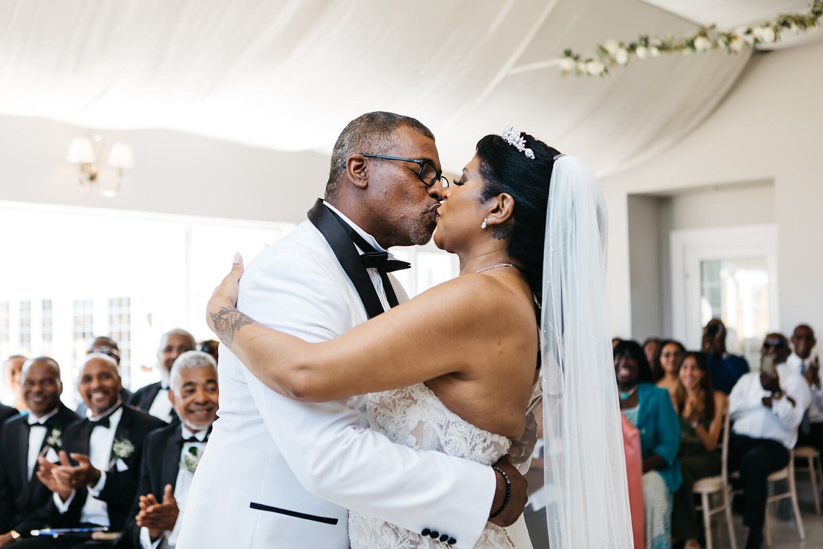 Black bride and groom hugging each other and kissing