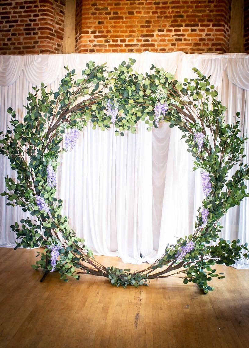 Wedding ceremony arch eucalyptus moongate with purple wisteria