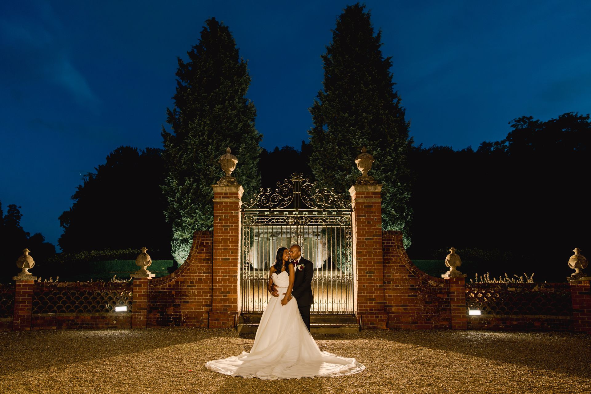 Black Bride and groom in moonlight outside the gates of Wotton House Hotel