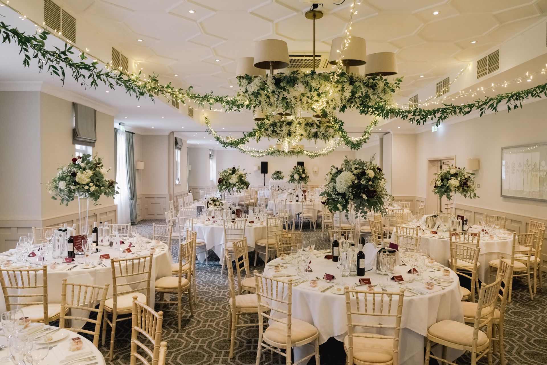 Elegant wedding reception set up with ceiling flower garlands