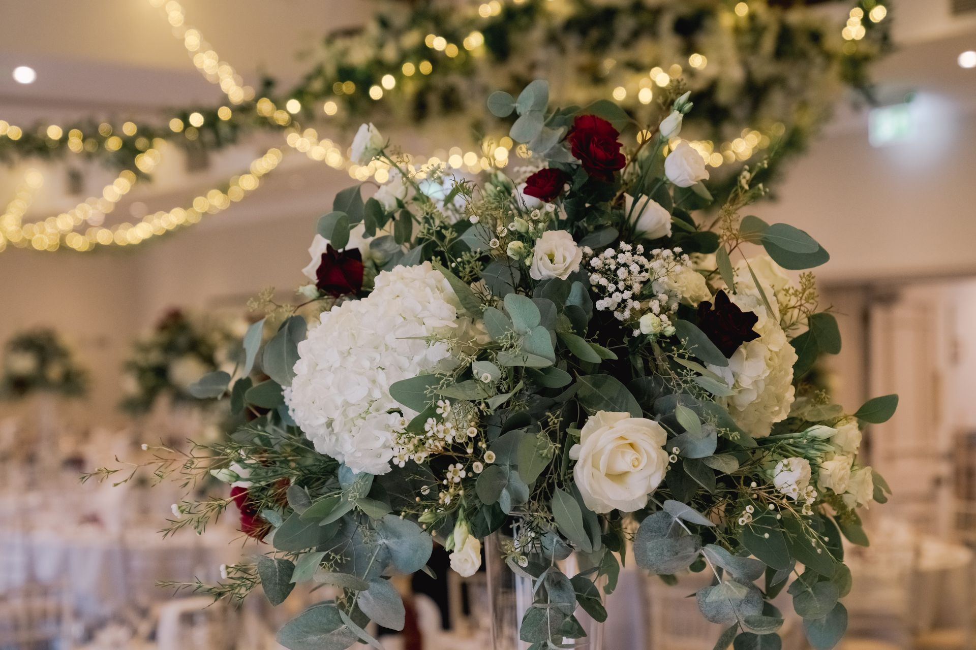 Red cream and foilage floral centrepiece