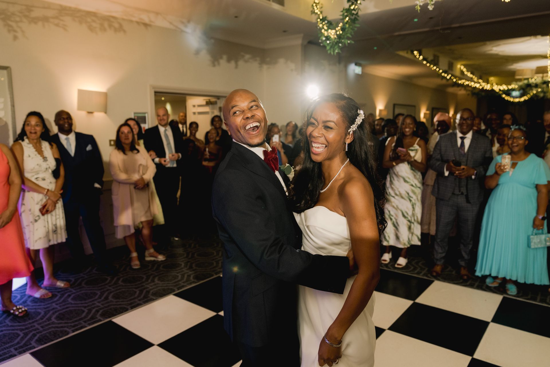 Black bride and groom hugging and dancing on the dance floor