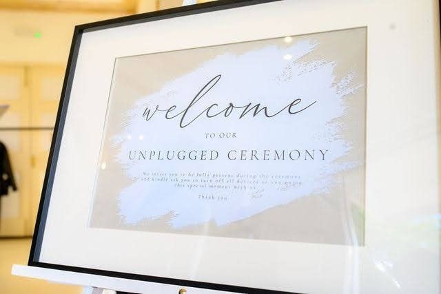 Unplugged ceremony sign framed in black glass frame