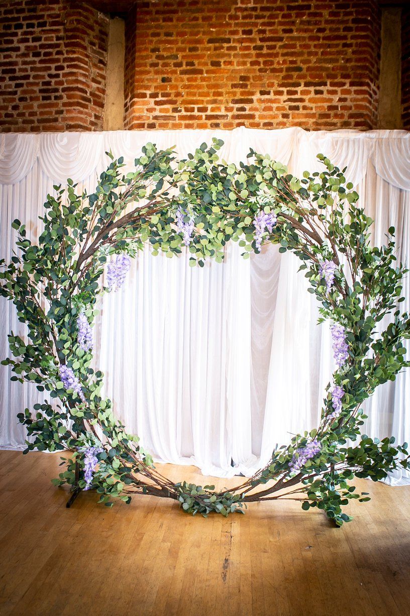 Wedding ceremony backdrop Eucalyptus moongate against white backdrop