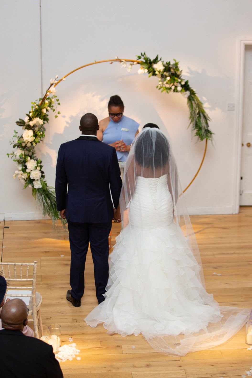 Black bride and groom holding hands at wedding ceremony