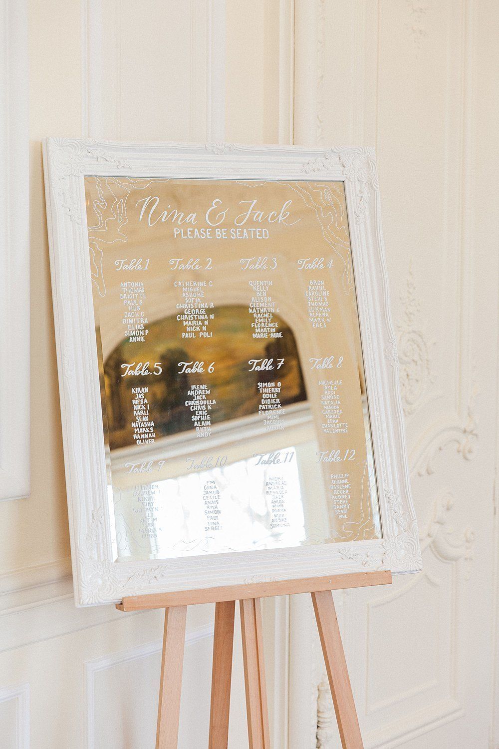 Cream coloured mirrored table seating display white calligraphy