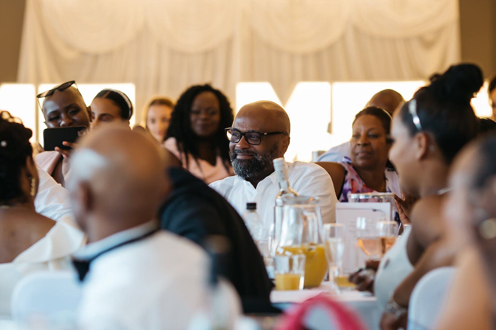 Wedding guests seated and smiling