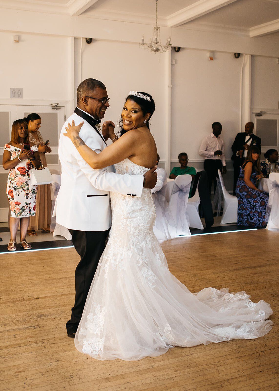 Black bride and groom having first dance on dance floor