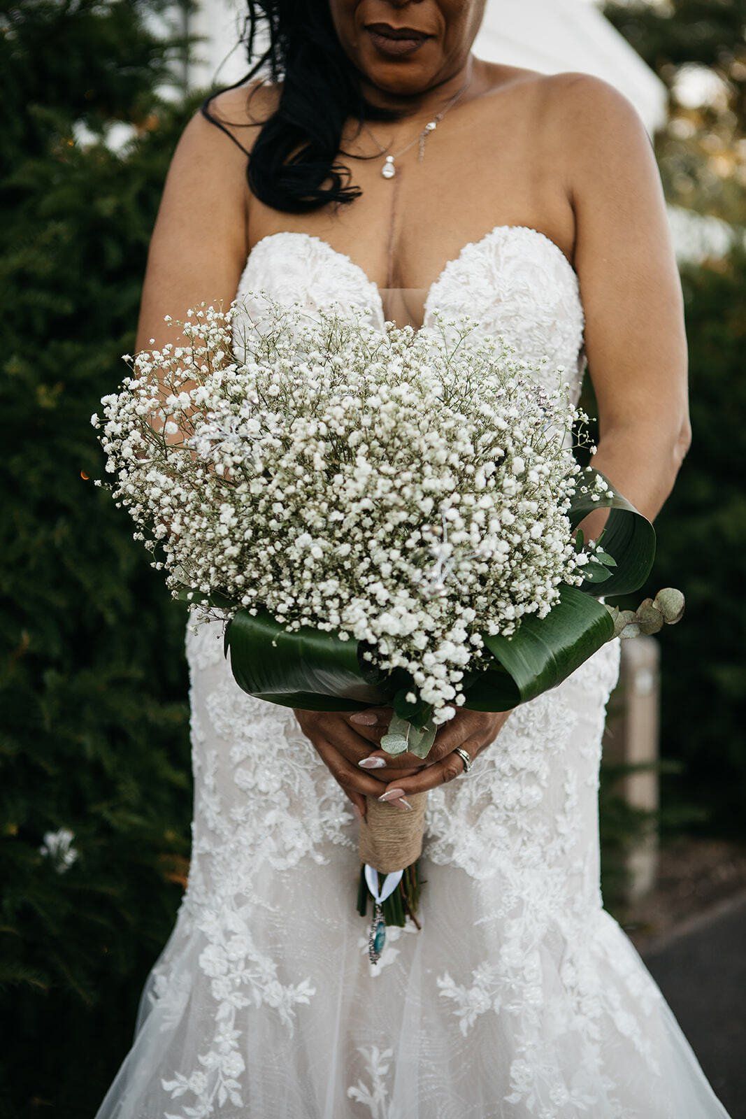 Close up of bride holding gypsophila wedding bouquet