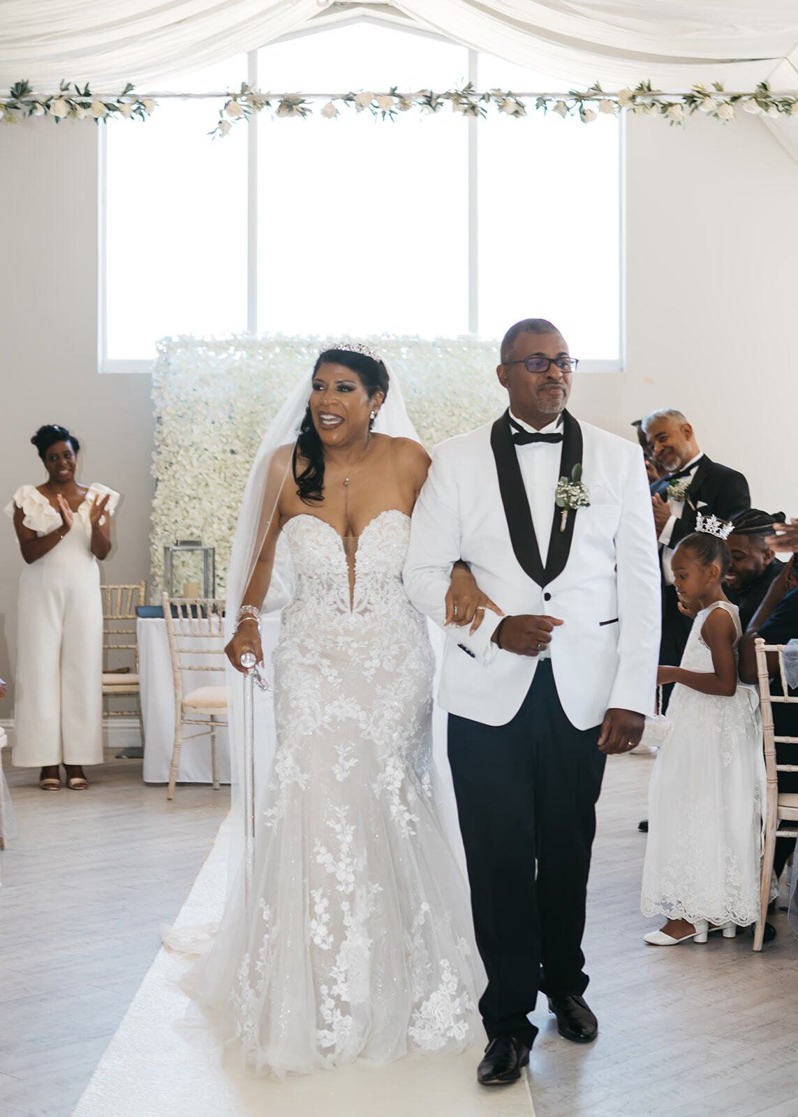 Black bride and groom married and walking up the wedding aisle