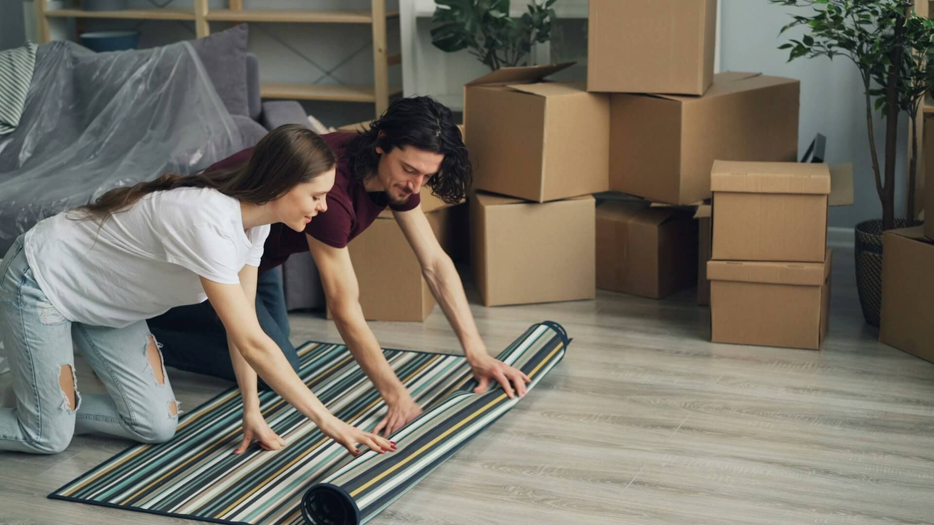 two people moving a carpet