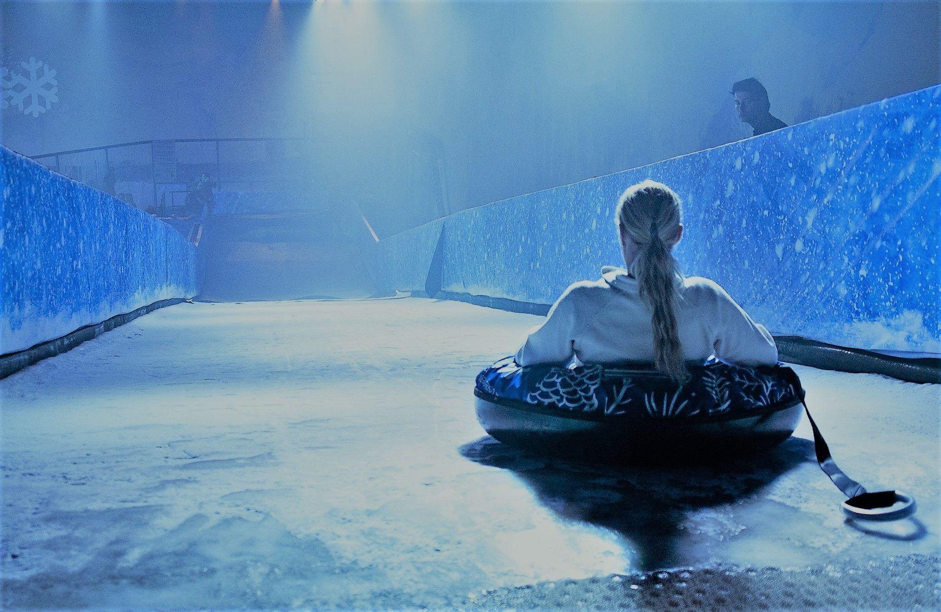 Full view of ice slide with rider waiting at the top to take the plunge