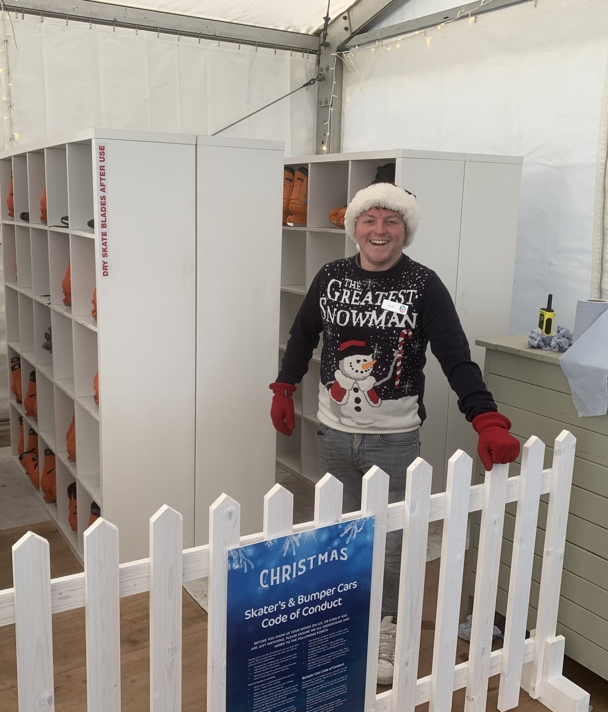 Photo of ice skate rack with the manager with a big smile