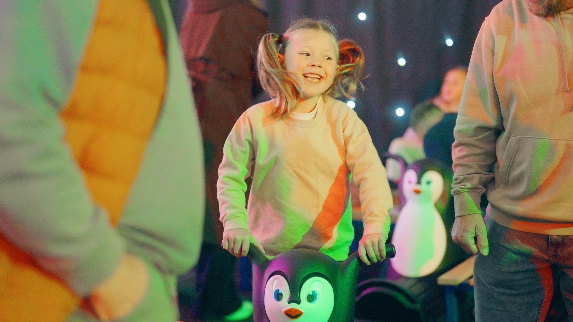 Young girl with Polly Penguin ice skate aid