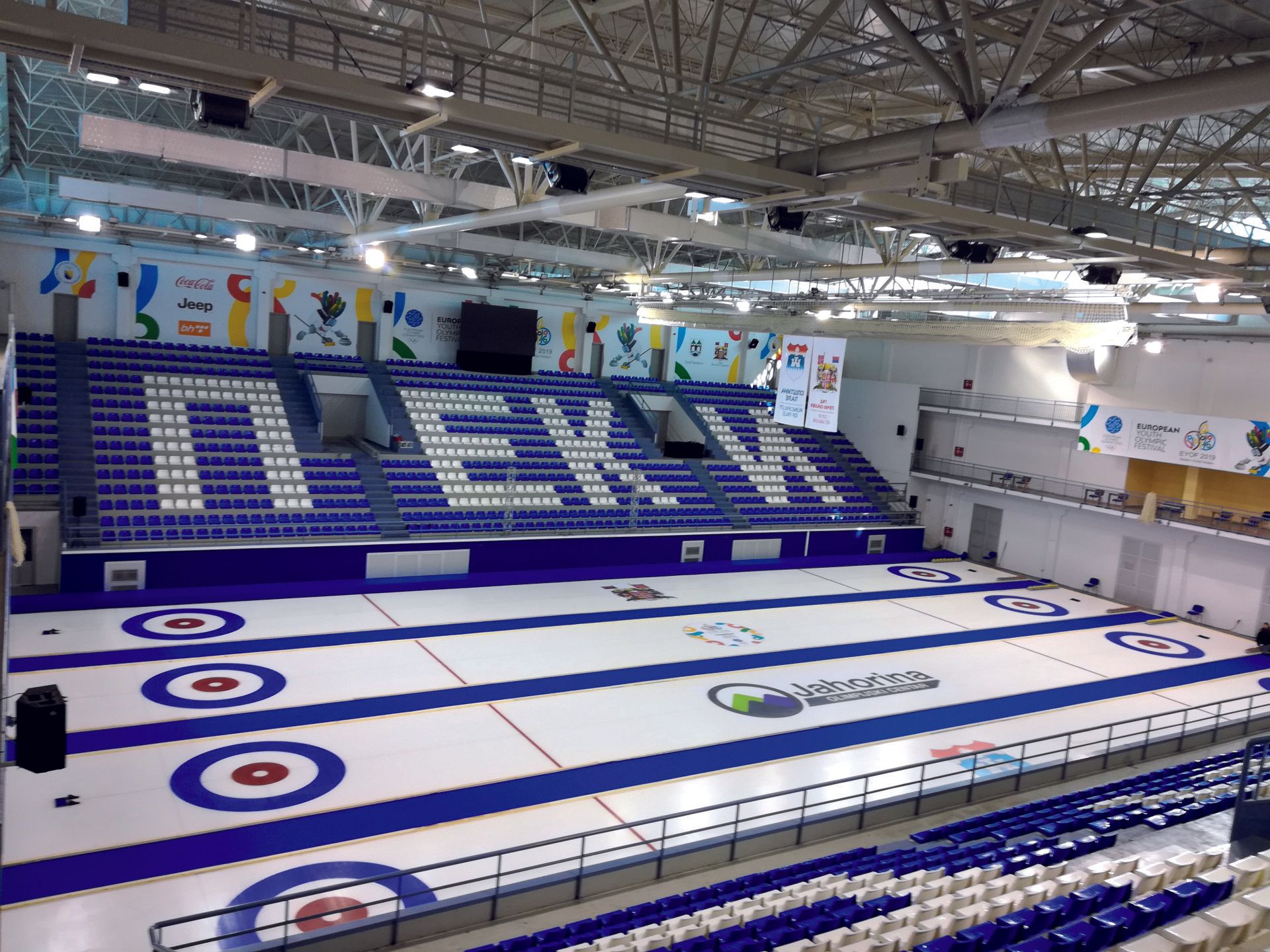 Curling ice rink with targets and grandstand seating