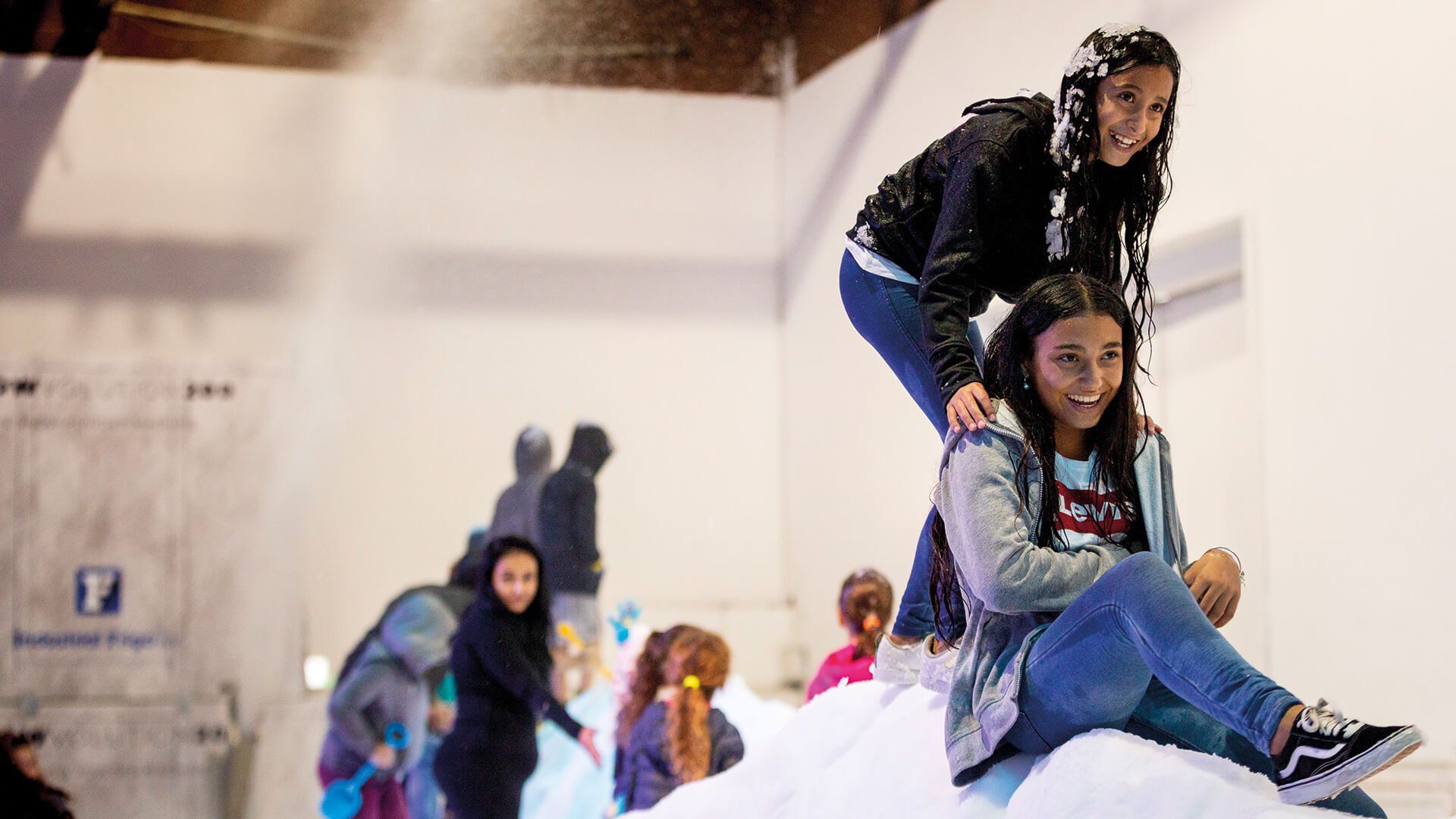 Young children playing in a snow enclosure